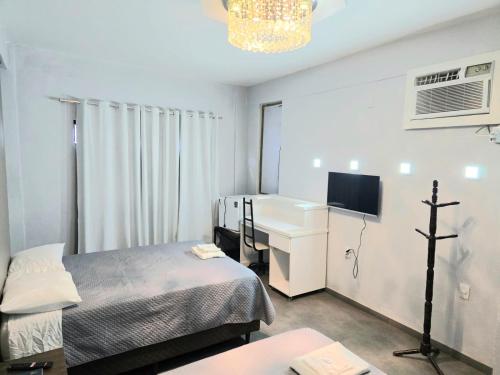 a hospital room with a bed and a sink at Hotel Diplomata in Tupanciretã