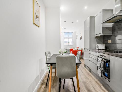 a kitchen with a table and a dining room at The Velvet Nest 2BR 2BA in Leicester