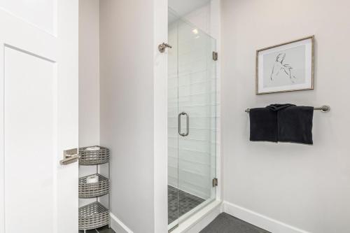 a shower with a glass door in a bathroom at Stylish Grand Lake Retreat - King Bed - Walk to Lake in Grand Lake