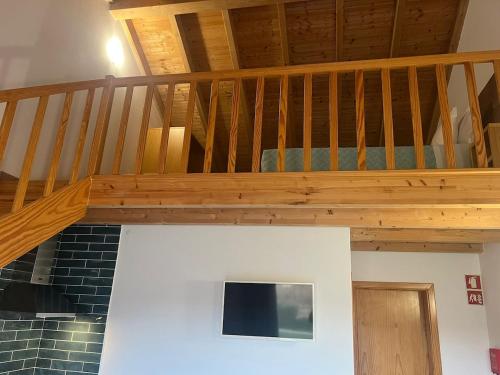 a wooden staircase in a living room with a stair case at Vila Lira in Aljezur