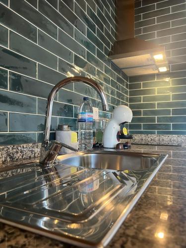 a kitchen sink with a faucet on top of it at Vila Lira in Aljezur