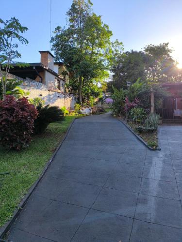 an empty sidewalk in front of a house at Guavirá cabañas and rooms in Puerto Iguazú