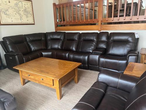 a living room with a leather couch and a coffee table at Great Kitchen, AC, SHARC Access, Hot Tub, Bring Pet! in Sunriver