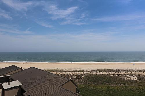 a view of a beach with a house and the ocean at Sea Colony - 709 Brandywine House Rd in Bethany Beach