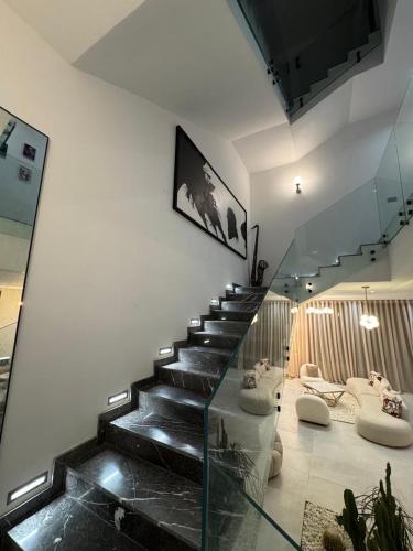 a staircase in a building with a glass floor at Luxury Villa with Heated Pool & Private cinema in Marrakesh