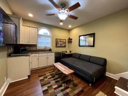 a living room with a couch and a kitchen at THE ADDAMS HOUSE - LANCASTER HISTORIC DISTRICT in Lancaster