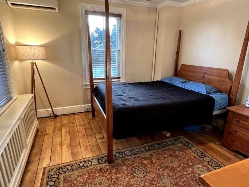 a bedroom with a bed and a lamp in it at THE ADDAMS HOUSE - LANCASTER HISTORIC DISTRICT in Lancaster