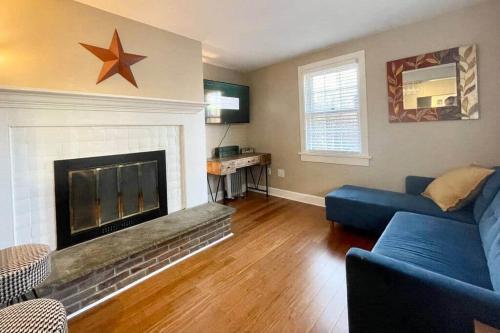 a living room with a blue couch and a fireplace at THE HANNAH HOUSE - DOWNTOWN HISTORIC LANCASTER in Lancaster