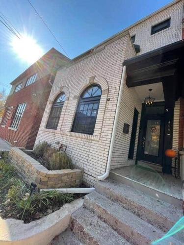 a brick house with a front door and stairs at THE STEVENS STUDIO - HISTORIC DOWNTOWN LANCASTER in Lancaster