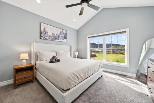 a bedroom with a bed and a window at Village Townhouse Walk to Shops Garage in Ellicottville