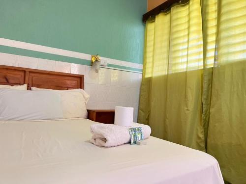 a bedroom with a bed with a towel on it at Hotel Hernandez in Chiquimula