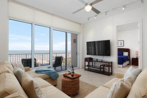 a living room with a couch and a flat screen tv at Prestigious Luxury Beach & Bay Patios XL Size in South Padre Island