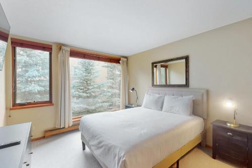 a bedroom with a large bed and a window at Simba Run 2305 in Vail