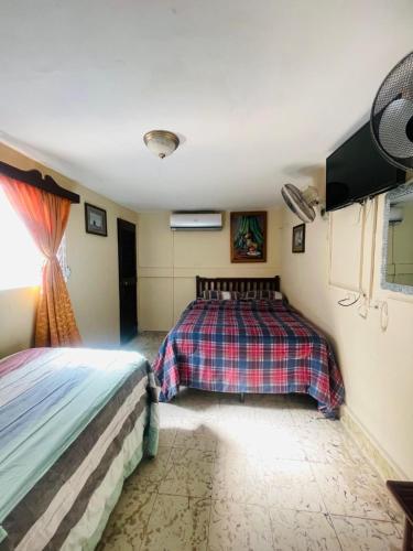 a bedroom with two beds in a room at Hotel Casa Morazán in Granada