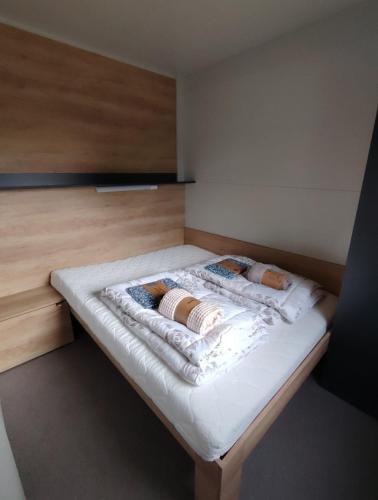 a bed in a room with two pillows on it at Mobile home RIA in Privlaka