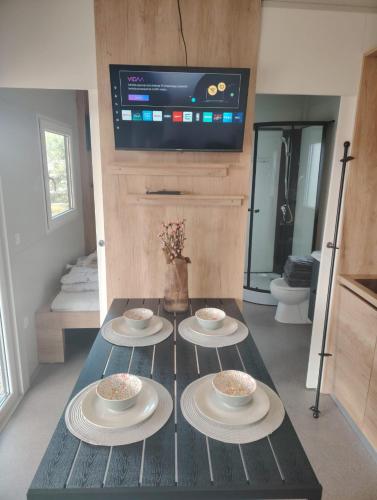 a room with a table with four plates on it at Mobile home RIA in Privlaka