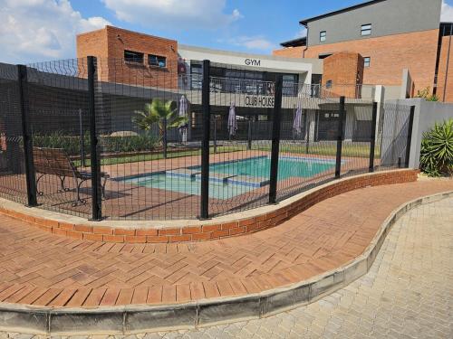 a fence around a swimming pool in a building at Eland Ridge in Boksburg
