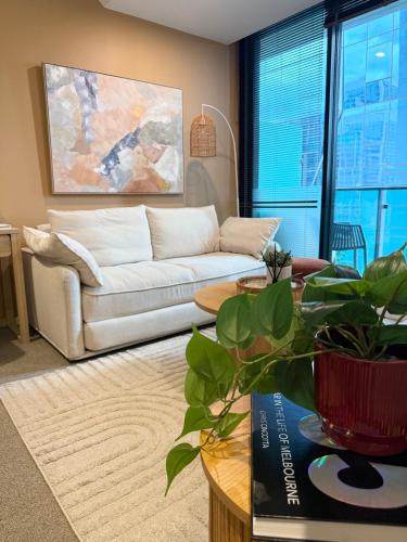 a living room with a couch and a table at CBD Apartment, Sleeps 4 with Free Car Park in Melbourne
