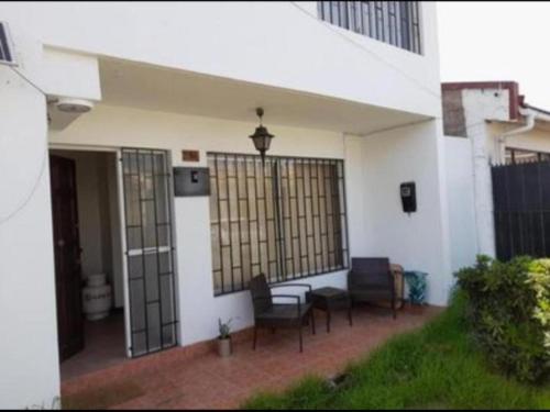 a patio with chairs and a table in a building at Pieza en el centro de La serena in La Serena