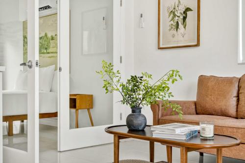 a living room with a couch and a table at Sleek Kitchenette & Queen Bed in Fort Lauderdale