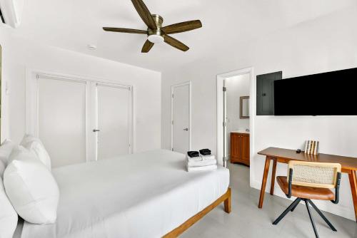 a white bedroom with a bed and a ceiling fan at Sleek Kitchenette & Queen Bed in Fort Lauderdale