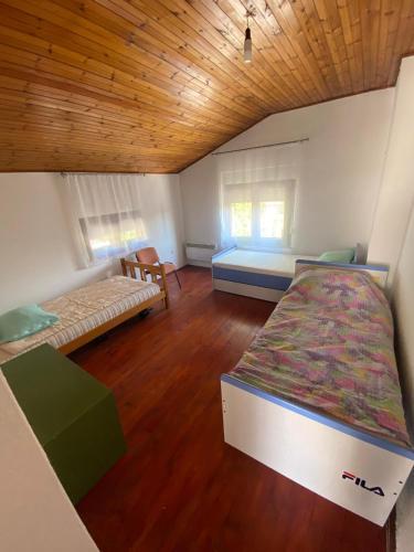 a bedroom with a bed and a couch in it at Apartman Dinja in Posušje