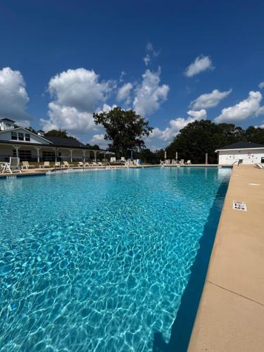 a large pool of blue water with chairs in it at Carolina Camp Cedar in Pickens