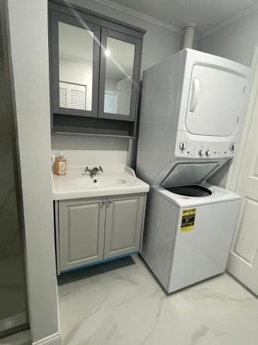 een kleine badkamer met een wastafel en een magnetron bij 海湾景观休闲独立屋可垂钓靠近达利博物馆 in St Petersburg