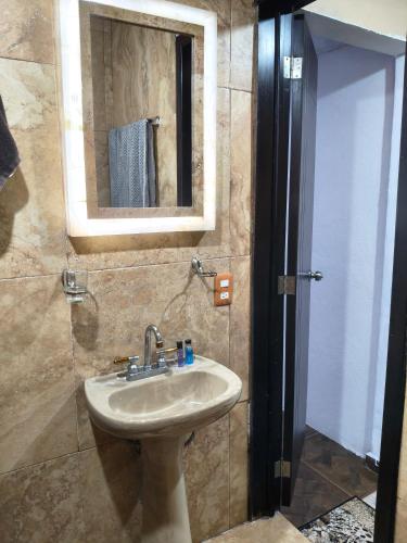 a bathroom with a sink and a mirror at Finca Chapis in San Sebastian Xolalpa