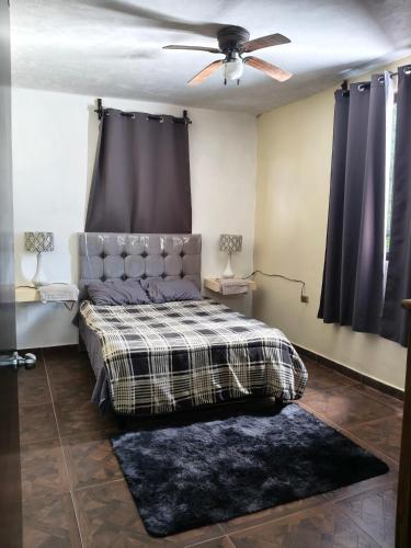 a bedroom with a bed and a ceiling fan at Finca Chapis in San Sebastian Xolalpa