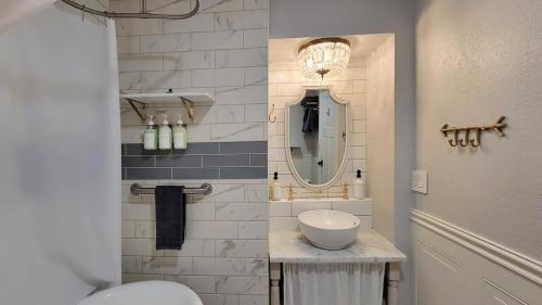 a bathroom with a sink and a mirror at Rosewood Collective by WanderLodges - Hot tub -Sauna in Medford