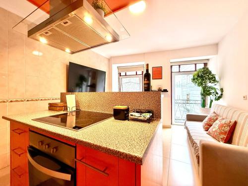 a kitchen with a counter and a stove top oven at Casa Dos Passos II in Guarda