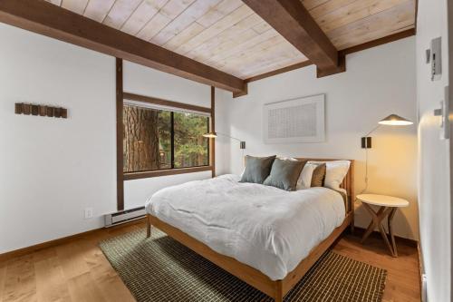a bedroom with a large bed and a window at Charming Tahoe Cabin in Incline Village