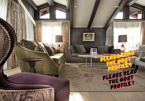 a living room with a couch and a table at Luxury Chalet Courchevel with Pool & Jacuzzzi in Courchevel
