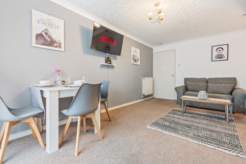 a living room with a table and a couch at Central Peaceful Home with Parking, Wi-Fi and Garden in Stafford