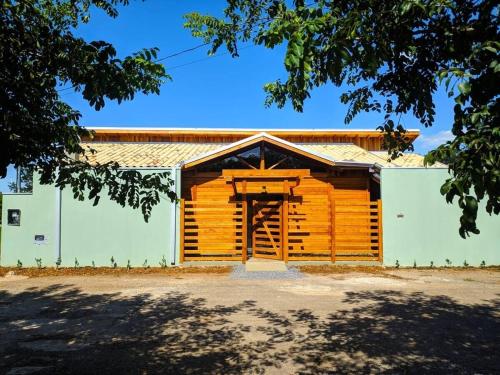 a wooden building with a large door in front at Chalé em meio a natureza de bonitoms in Bonito