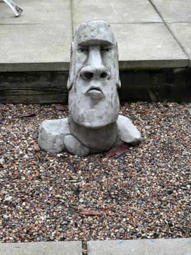 a statue of a head sitting on the ground at Stylish Town House in Medieval Grid in Bury Saint Edmunds