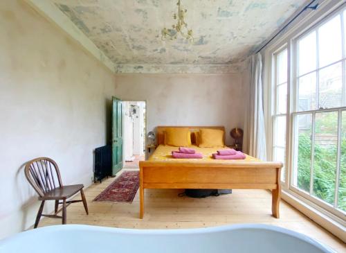 a bedroom with a bed and a large window at Sea Garden in Hastings