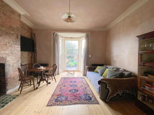 a living room with a couch and a table at Sea Garden in Hastings