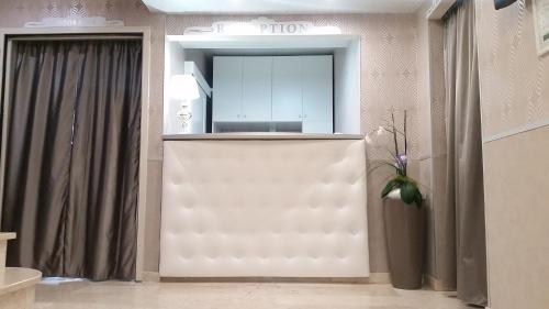 サン・ジョヴァンニ・ロトンドにあるHotel Leon - Ristorante Al Cavallino Rossoの鏡付きの部屋の白いドア