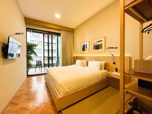 a bedroom with a large bed and a balcony at ANA Polanco in Mexico City