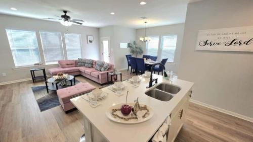 a kitchen and living room with a couch and a table at The Tigers Pathway House near LSU Stadium - BC1034 in Collegetown