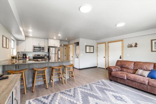 a kitchen and living room with a couch and a counter at Lorene St Condo in Rexburg