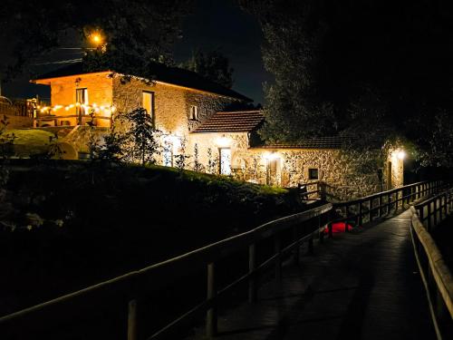 a building with lights on the side of it at night at Uíma River House 