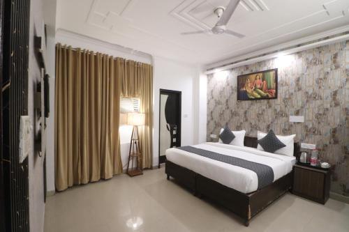 a bedroom with a large bed in a room at Hotel Luck Recdancy mahipalpur in New Delhi
