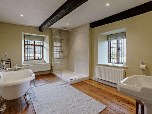 a large bathroom with two sinks and a shower at 4 Bed in Llanover 91243 in Abergavenny