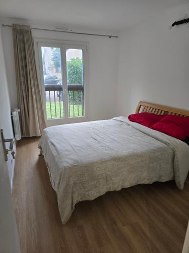 a white bedroom with a large bed and a window at chambre - Paris - salons & missions pro in Montrouge