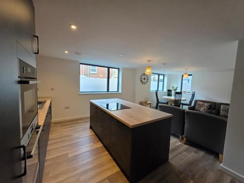 an open living room with a kitchen and a living room at Suite Bowl in Exmouth