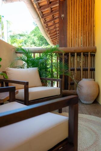 a living room with a couch and a table at Pousada Por do Sol Trancoso in Trancoso