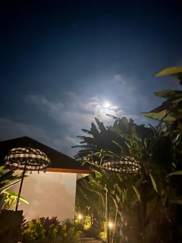 a night view of a house with the moon in the sky at Sidemen padi villas in Silebeng